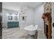 An airy bathroom boasts a clawfoot tub, shower, double vanity, and colorful decor at 605 W Holt St, Mebane, NC 27302