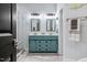 Well-lit bathroom with double vanity sinks, walk-in shower, and stone accents at 605 W Holt St, Mebane, NC 27302