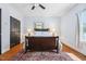 Cozy bedroom with hardwood floors, ceiling fan, and a decorative area rug at 605 W Holt St, Mebane, NC 27302