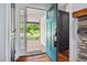 View from the foyer featuring hardwood floors and a teal-colored door leading to the porch at 605 W Holt St, Mebane, NC 27302