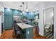 Modern kitchen with blue cabinets, stainless steel appliances, and a marble countertop island at 605 W Holt St, Mebane, NC 27302