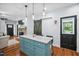 Kitchen island with marble countertop and seating, open to the living room at 605 W Holt St, Mebane, NC 27302