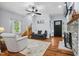 Bright living room with hardwood floors, comfortable seating, and staircase to the upper level at 605 W Holt St, Mebane, NC 27302