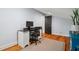 Comfortable office space with hardwood floors, computer desk, rolling chair, and natural light at 605 W Holt St, Mebane, NC 27302