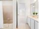 Bathroom with combined tub and shower combination with a vanity that has lots of counter space at 619 Baybush Dr, Raleigh, NC 27615