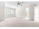 Spacious and carpeted bedroom with a window, closet and a view into the ensuite bathroom at 619 Baybush Dr, Raleigh, NC 27615