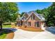 Expansive circular driveway leads to this beautiful brick home with lush landscaping and attached garage at 619 Baybush Dr, Raleigh, NC 27615