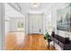 Bright foyer with hardwood floors, white trim, and a view into the formal living and dining areas at 619 Baybush Dr, Raleigh, NC 27615
