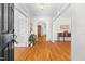 Inviting home foyer boasts gleaming hardwood floors, neutral paint, and elegant arched doorway at 619 Baybush Dr, Raleigh, NC 27615