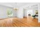 Spacious living room with hardwood floors, chandelier, large windows, and traditional decorative accents at 619 Baybush Dr, Raleigh, NC 27615
