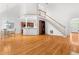 Expansive living area with hardwood floors, vaulted ceilings, and staircase leading to an upper level at 619 Baybush Dr, Raleigh, NC 27615