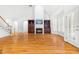 Spacious living room featuring hardwood floors, a fireplace, built-in shelving, and natural light at 619 Baybush Dr, Raleigh, NC 27615