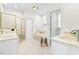 Bright main bathroom with double vanities, walk-in shower and soaking tub area with arched window at 619 Baybush Dr, Raleigh, NC 27615