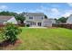 Expansive backyard featuring a lush lawn, patio area, and wooden fence for privacy at 6228 Saybrooke Dr, Raleigh, NC 27604