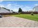 Large paved patio with backyard featuring a wood fence and green grass at 6228 Saybrooke Dr, Raleigh, NC 27604