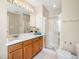 Bright bathroom featuring a glass shower, white sink with wooden cabinets, and a well-lit mirror at 6228 Saybrooke Dr, Raleigh, NC 27604