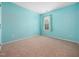 Inviting bedroom featuring plush carpeting, a window with curtains, and calming turquoise walls at 6228 Saybrooke Dr, Raleigh, NC 27604