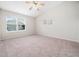 Bright bedroom with a ceiling fan, large windows allowing for ample natural light and neutral carpet at 6228 Saybrooke Dr, Raleigh, NC 27604