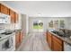 Well-lit kitchen with modern appliances, granite countertops, and a sliding glass door that leads to the backyard at 6228 Saybrooke Dr, Raleigh, NC 27604