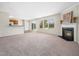 Spacious living room with fireplace, carpet flooring, and sliding door access to the backyard at 6228 Saybrooke Dr, Raleigh, NC 27604