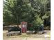 Well-maintained park entrance with clear signage, a paved walkway, and natural landscaping at 6228 Saybrooke Dr, Raleigh, NC 27604