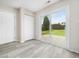 Versatile sunroom with laminate flooring, featuring a sliding glass door that opens to the backyard patio at 6228 Saybrooke Dr, Raleigh, NC 27604