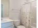 Well-lit bathroom with a vanity, toilet, and a shower with a floral-patterned curtain at 660 Still Willow Ln, Wendell, NC 27591