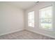 Bright bedroom with carpet flooring, two large windows, and neutral walls at 660 Still Willow Ln, Wendell, NC 27591