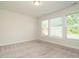 Cozy bedroom featuring neutral carpet and natural light from large windows at 660 Still Willow Ln, Wendell, NC 27591