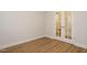 A bright, spacious bedroom featuring hardwood floors and glass paneled french doors at 660 Still Willow Ln, Wendell, NC 27591