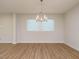 Bright dining area features hardwood floors and a modern chandelier at 660 Still Willow Ln, Wendell, NC 27591