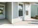 View of the home's siding and windows, with a view to the front door and landscaping details at 660 Still Willow Ln, Wendell, NC 27591