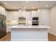 Modern kitchen with stainless steel appliances, white cabinets and a center island at 660 Still Willow Ln, Wendell, NC 27591