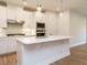 Modern kitchen with stainless steel appliances, white cabinets and a center island at 660 Still Willow Ln, Wendell, NC 27591