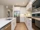 Modern kitchen with stainless steel appliances, white cabinets, and quartz countertops at 660 Still Willow Ln, Wendell, NC 27591