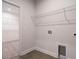 Clean laundry room with tile flooring and wire shelving, with access to a walk-in closet at 660 Still Willow Ln, Wendell, NC 27591