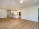 Open-concept living room and kitchen with hardwood floors and white cabinets, offering ample space for entertaining at 660 Still Willow Ln, Wendell, NC 27591
