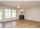 Spacious living room with hardwood floors, a fireplace, and a view of the backyard through the glass door at 660 Still Willow Ln, Wendell, NC 27591