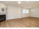 Spacious living room featuring hardwood floors, a fireplace, and modern lighting at 660 Still Willow Ln, Wendell, NC 27591