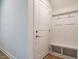 Inviting mudroom area with storage hooks, a bench, and a shelf near the front door at 660 Still Willow Ln, Wendell, NC 27591