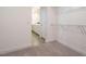 Walk-in closet with carpet flooring and wire shelving, leading to the white-cabinet bathroom at 660 Still Willow Ln, Wendell, NC 27591