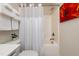 Bright bathroom featuring shower with curtain, toilet, and soft white towels at 7809 Lillyhurst Dr, Raleigh, NC 27612