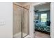 En suite bathroom showcasing glass shower, tile surround, and doorway into bedroom at 7809 Lillyhurst Dr, Raleigh, NC 27612