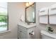 Bright bathroom featuring single vanity, neutral decor, toilet, and window at 7809 Lillyhurst Dr, Raleigh, NC 27612