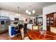 Open-concept view into kitchen and dining area with stainless steel appliances and white cabinetry at 7809 Lillyhurst Dr, Raleigh, NC 27612