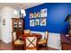 Dining area showcasing a dark wood table, stylish chairs and rooster art, and hardwood floors at 7809 Lillyhurst Dr, Raleigh, NC 27612