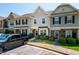 View of townhome exteriors, showing landscaping and parking at 7809 Lillyhurst Dr, Raleigh, NC 27612