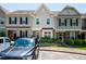 Townhomes feature manicured landscaping, covered entries, and visible house numbers for easy identification at 7809 Lillyhurst Dr, Raleigh, NC 27612