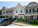 Townhomes feature manicured landscaping, covered entries, and visible house numbers for easy identification at 7809 Lillyhurst Dr, Raleigh, NC 27612