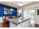 Bright kitchen featuring an island with seating, stainless appliances, and an adjacent dining area at 7809 Lillyhurst Dr, Raleigh, NC 27612